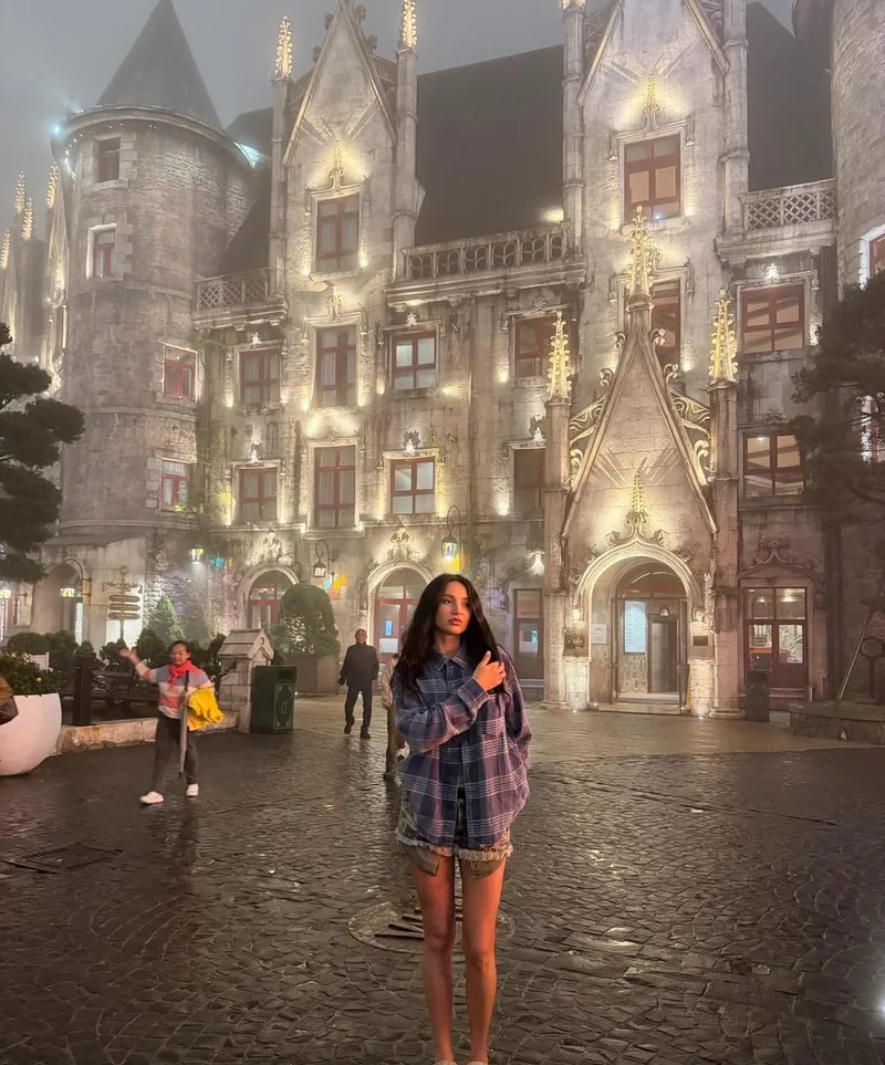 Ba Na Hills French Village gothic buildings in evening mist — atmospheric mountain resort atmosphere — day trip from Hoi An