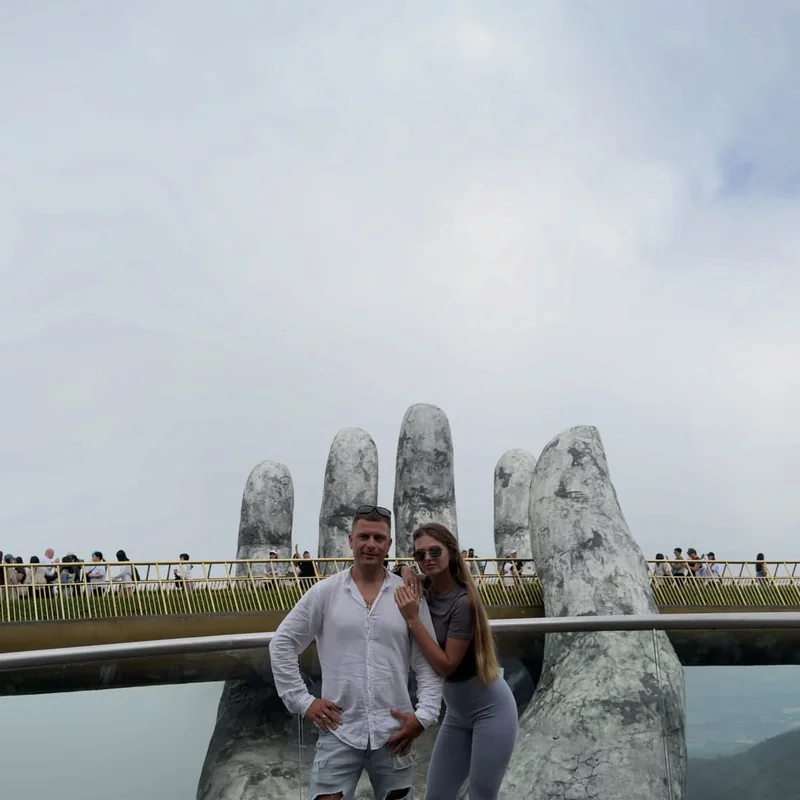 Couple at Ba Na Hills Golden Bridge — giant stone hands supporting the walkway — best photographed before 9 AM