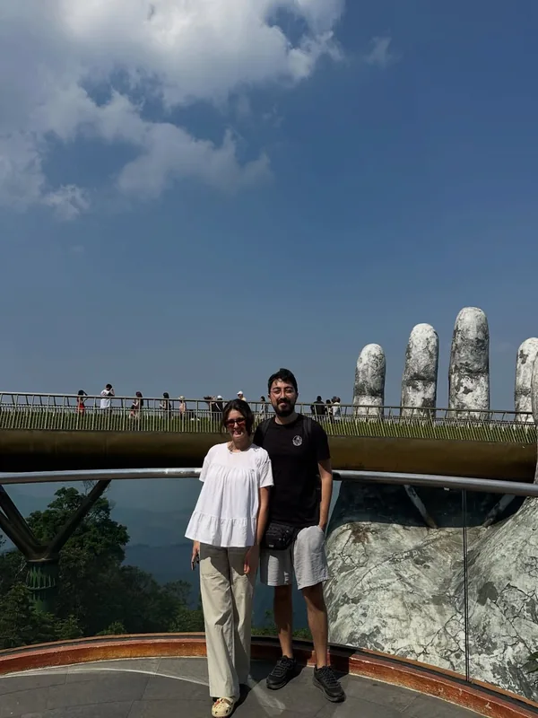Visitors at Ba Na Hills Golden Bridge with giant stone hands — arrive from Hoi An by 8 AM for the best experience — Minh Vu Travel
