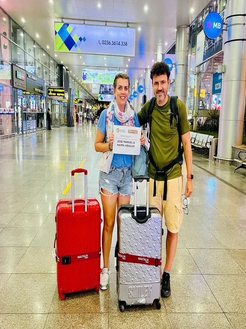 Guests welcomed at Da Nang Airport arrivals hall by Minh Vu Travel driver with personalised name board — private car transfer to Hoi An