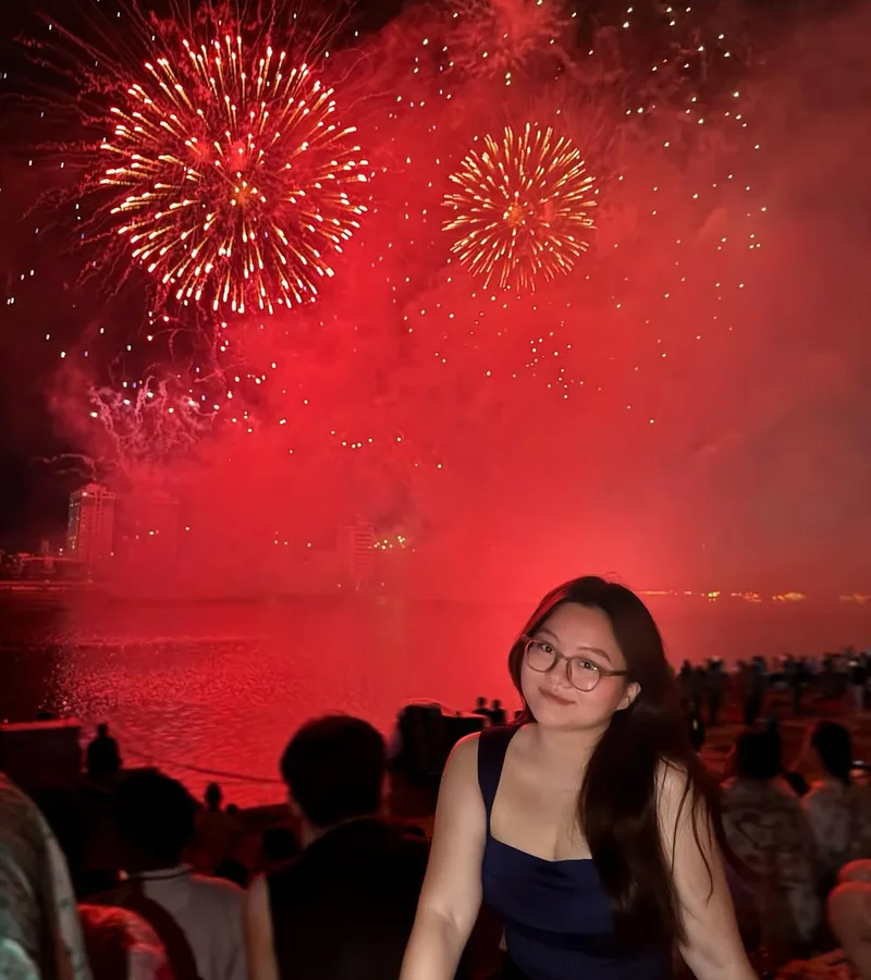 Crowd watching DIFF fireworks on the Han River Da Nang — red fireworks light up the night sky — competition atmosphere