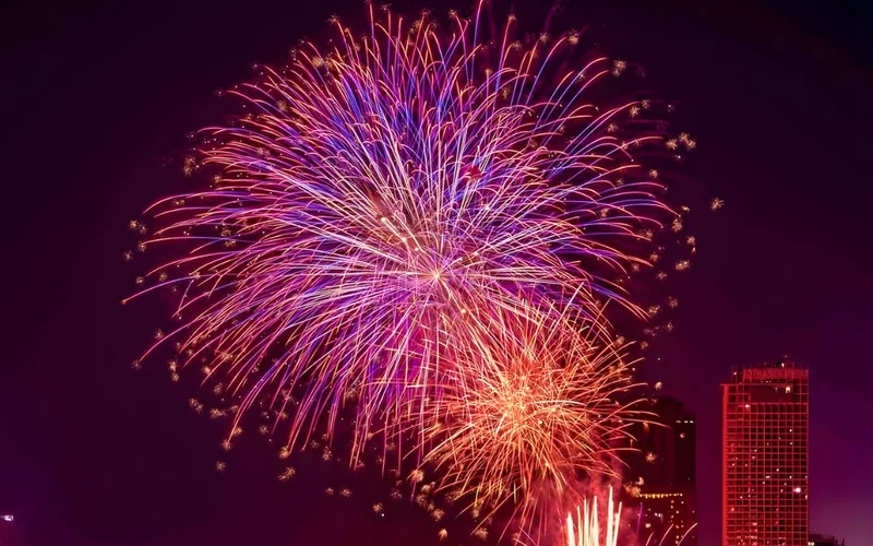 Da Nang Han River at night during DIFF 2026 — Dragon Bridge, Sun Wheel and fireworks over the water