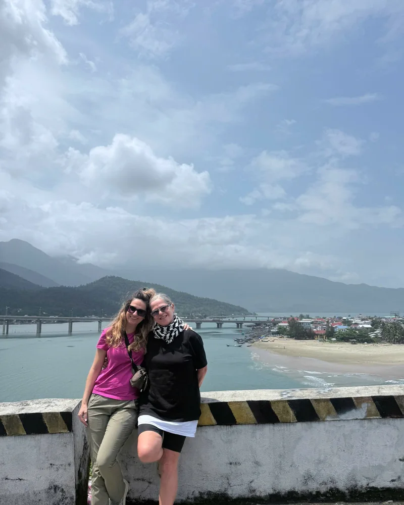 Visitors at Hai Van Pass summit viewpoint overlooking Lang Co lagoon and bay — 496m above sea level on the Hoi An to Hue route