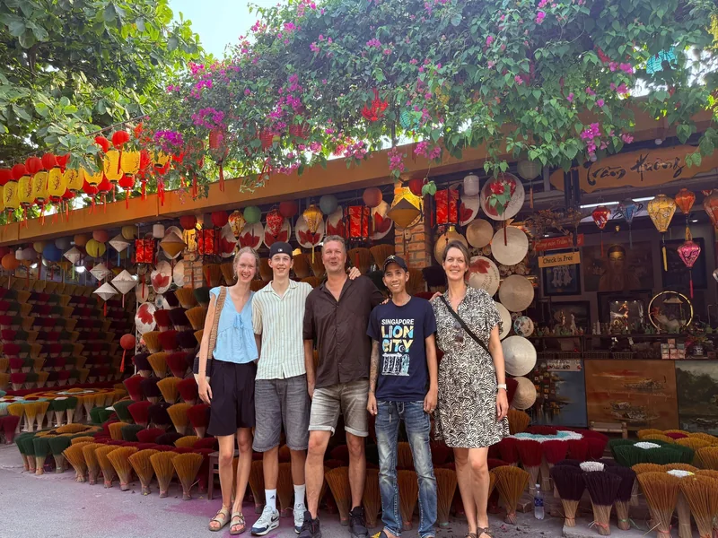 Family with Minh Vu Travel driver at Hoi An — departing for Hue via Hai Van Pass — private car day trip Central Vietnam