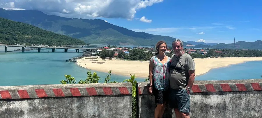 Couple at Hai Van Pass viewpoint overlooking Lang Co lagoon