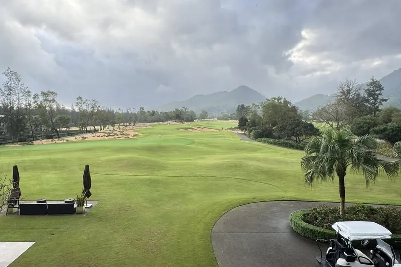 Laguna Golf Lang Co championship course with mountain backdrop — Banyan Tree Laguna resort grounds