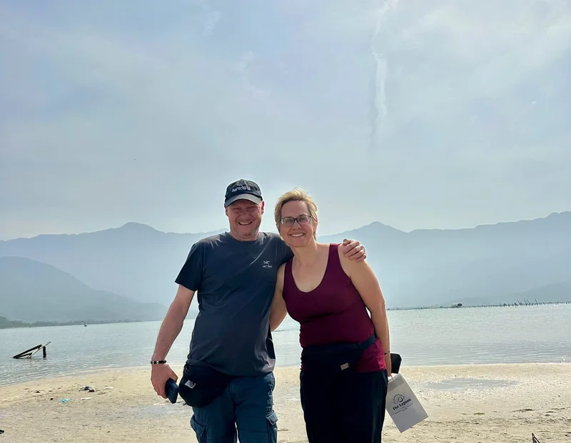 Couple at Lap An Lagoon beach stop on the Hoi An to Hue private car route — Lang Co, Thua Thien Hue Province