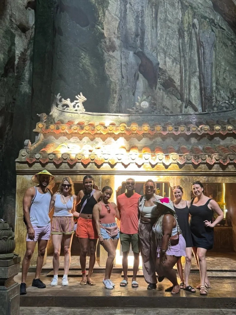 Group inside Huyen Khong Cave at Marble Mountains Da Nang — illuminated shrine inside the cave — half-day stop from Hoi An