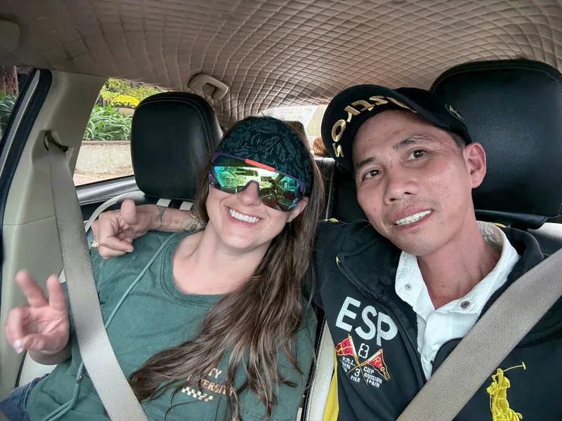 Minh Vu Travel driver with happy passenger during Da Nang to Hoi An private car transfer — friendly and reliable service
