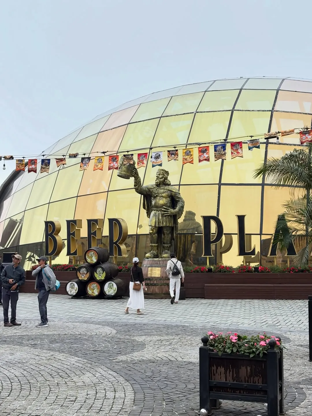 Beer Plaza buffet restaurant exterior at Ba Na Hills with golden dome and bronze Viking statue — the most popular large buffet venue on the mountain
