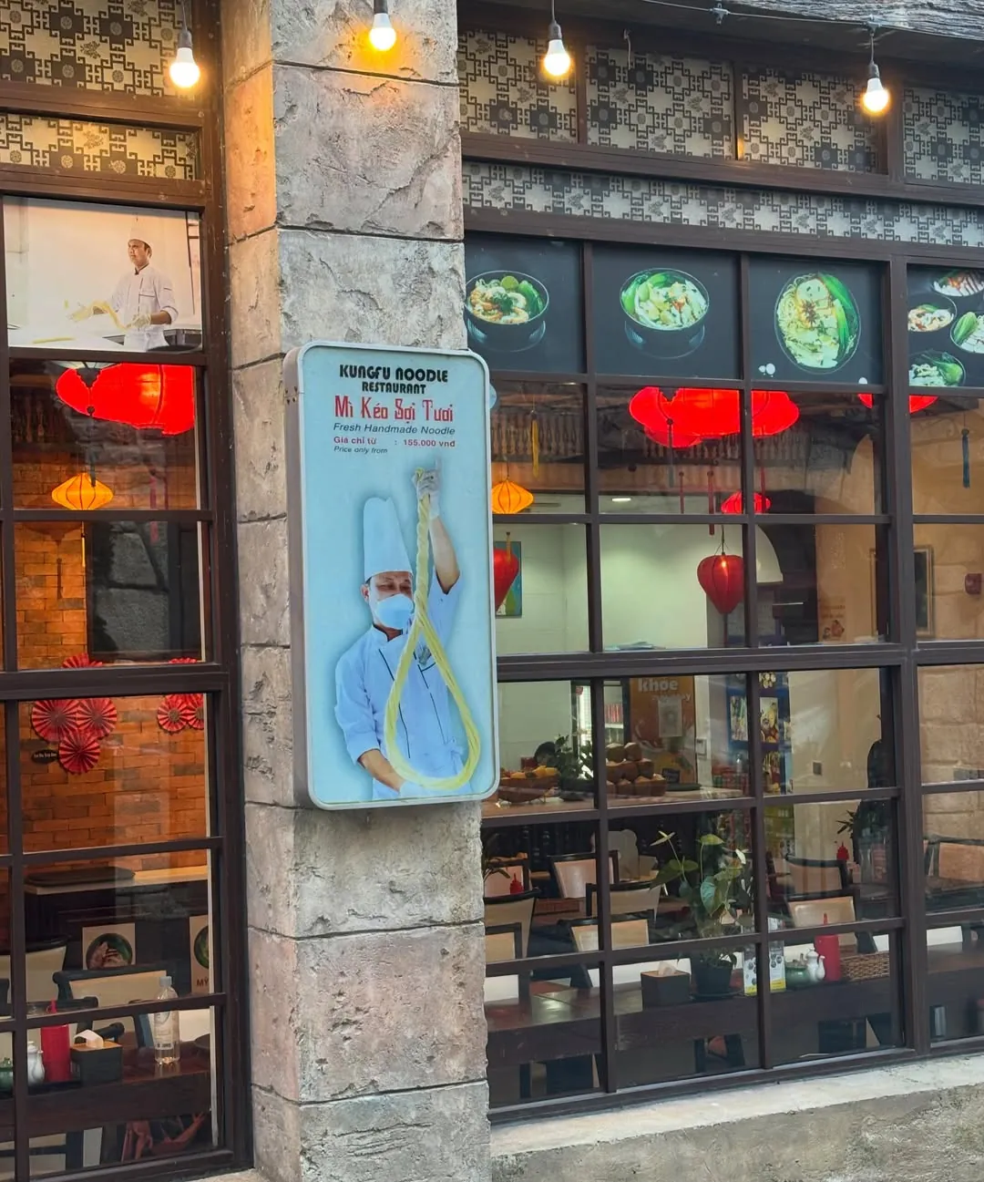 Kungfu Noodle Restaurant sign at Ba Na Hills advertising fresh handmade noodles from 155,000 VND — one of the à la carte options on the mountain
