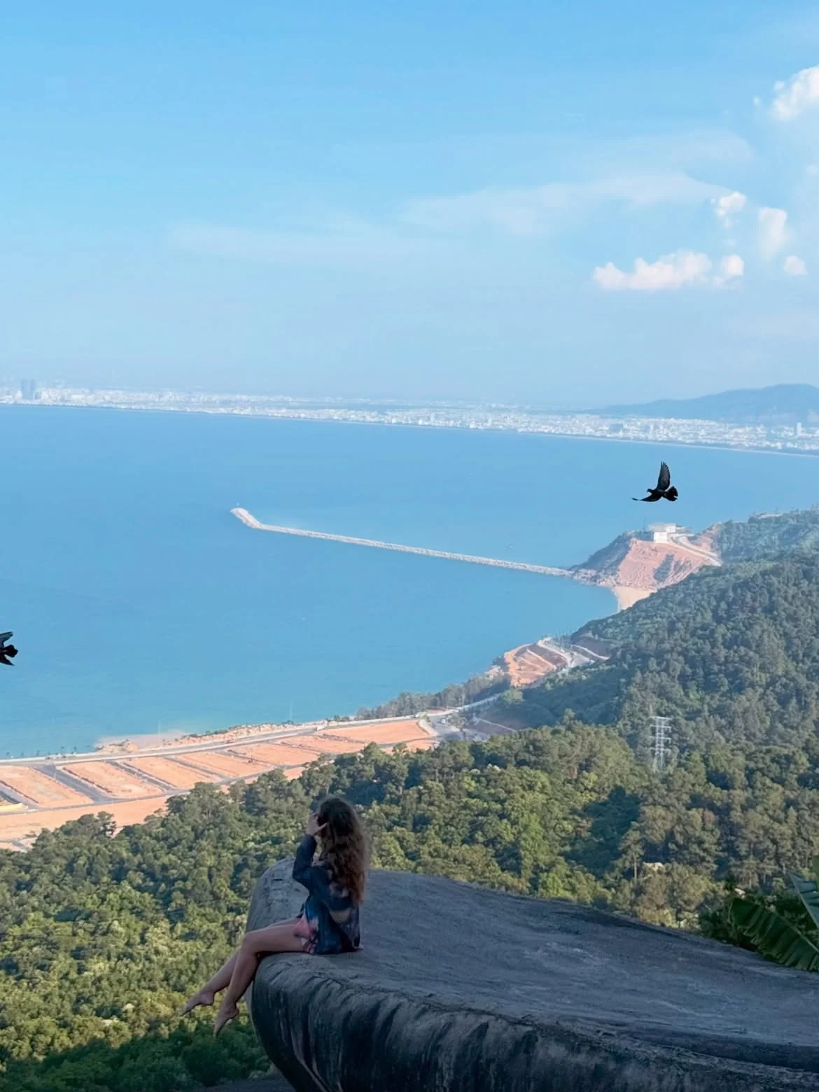 View from Hai Van Pass on the Da Nang to Hue scenic route with Da Nang Bay and blue sea below