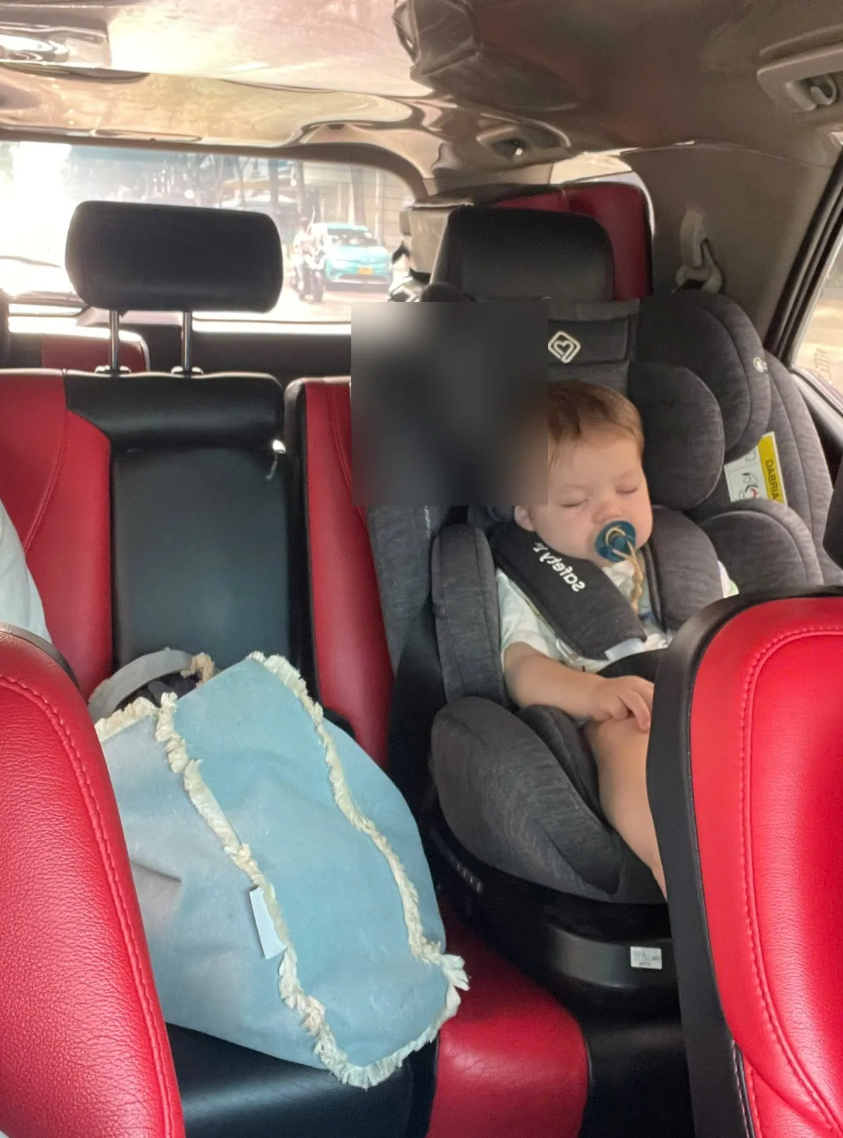 Clean infant car seat installed inside a private transfer vehicle