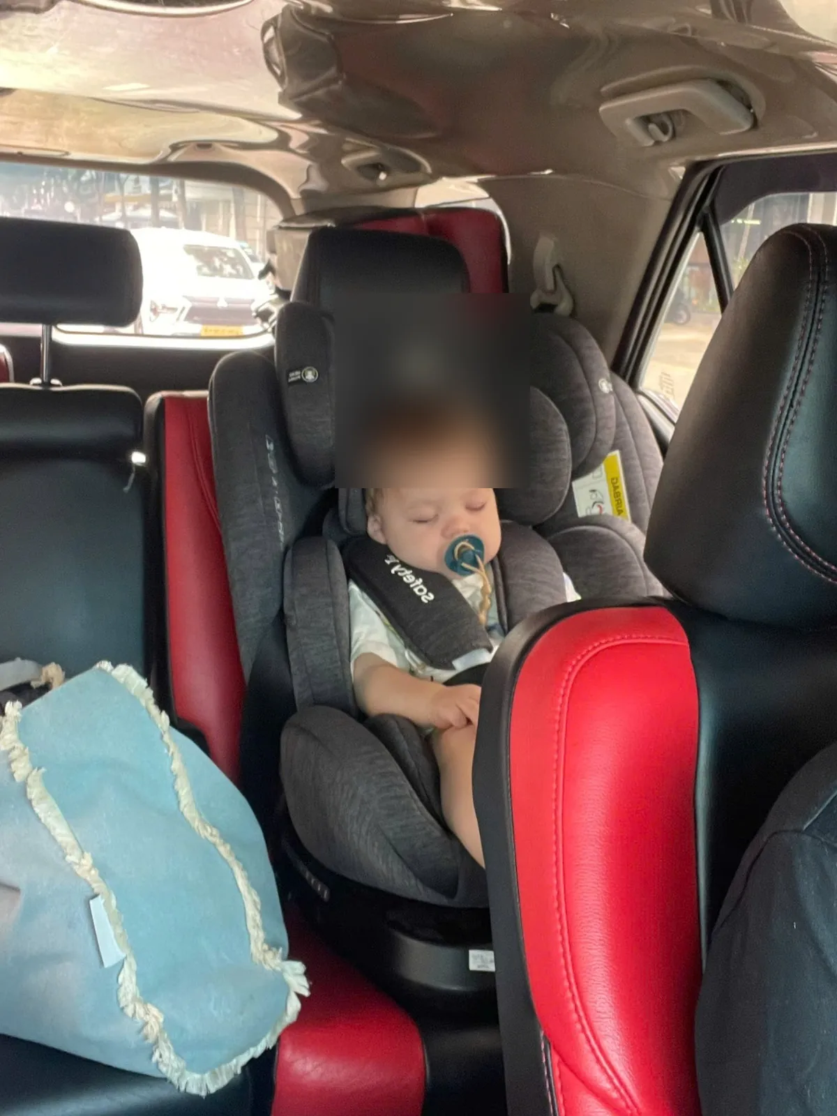 Infant car seat prepared inside private car for Da Nang airport transfer