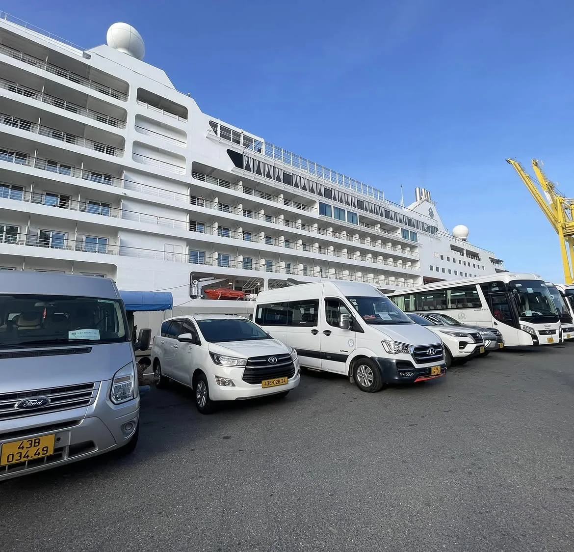 Private cars and vans lined up at Chan May Port pier for cruise passenger shore excursions